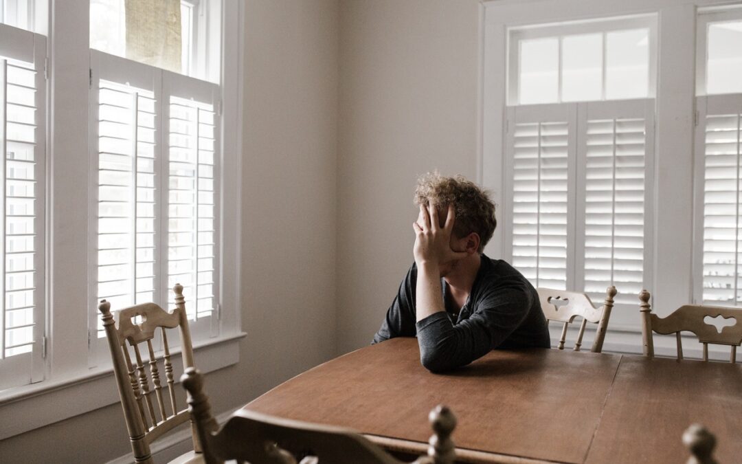 Man sitting along at a table